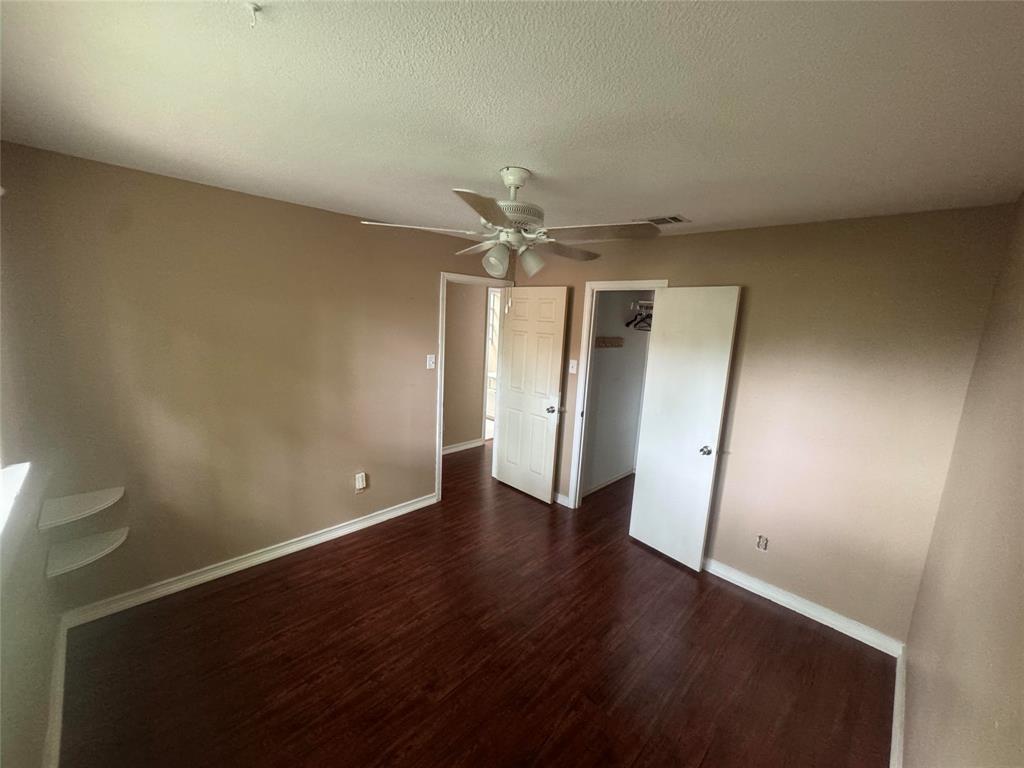 4649 Misty Ridge Drive Fort Worth, TX 76137 - Photo 2 of 25 an empty room with wooden floor and a ceiling fan