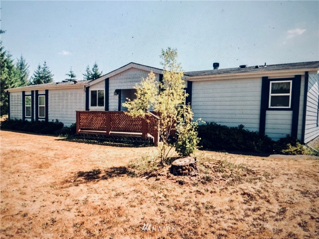 110-166 Rawlins Road Winlock, WA 98596 - Photo 1 of 1 a front view of a house with a yard covered in snow
