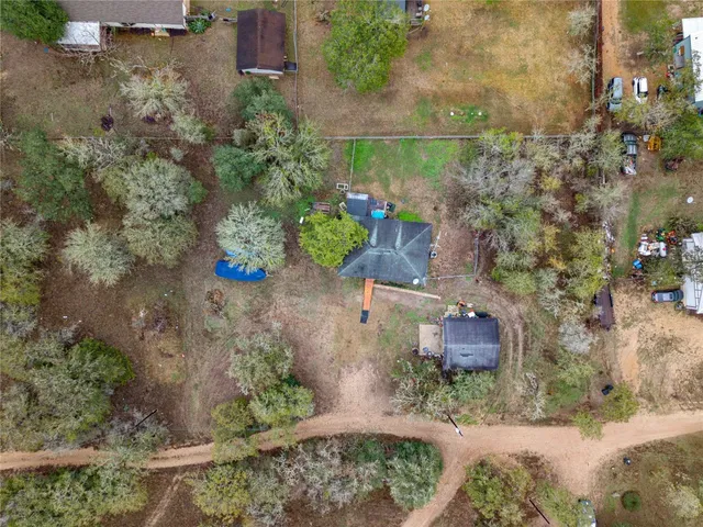 an aerial view of a house with a yard