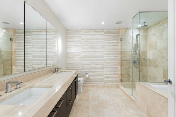 1 Franklin Street, Unit 2307 Boston, MA 02110 - Photo 26 of 27 a bathroom with a tub sink and mirror