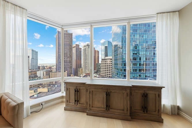 1 Franklin Street, Unit 2307 Boston, MA 02110 - Photo 3 of 27 a living room with a large window and walk in closet