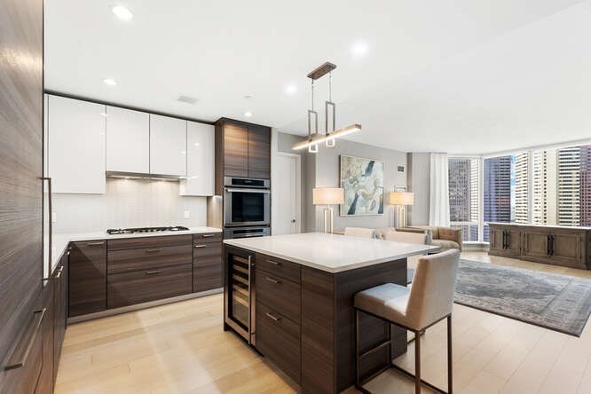 1 Franklin Street, Unit 2307 Boston, MA 02110 - Photo 9 of 27 a kitchen with stainless steel appliances a sink stove and refrigerator