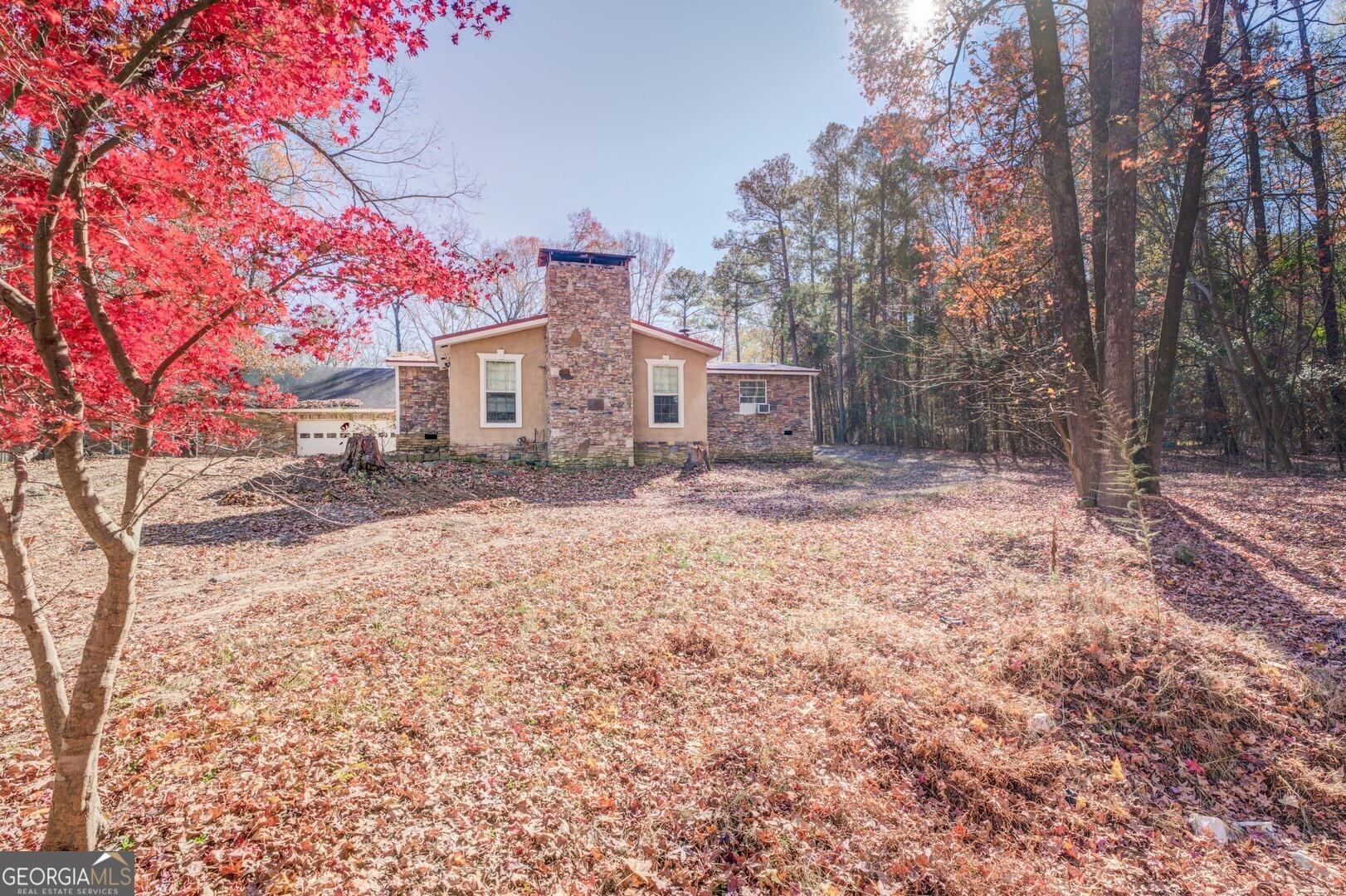 154 Arrow Point Road Jackson, GA 30233 - Photo 1 of 1 a front view of a house with a yard covered in snow