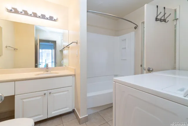 a bathroom with a sink vanity and a mirror