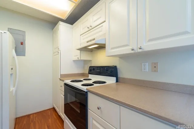 a kitchen with stainless steel appliances granite countertop a sink a stove and a refrigerator