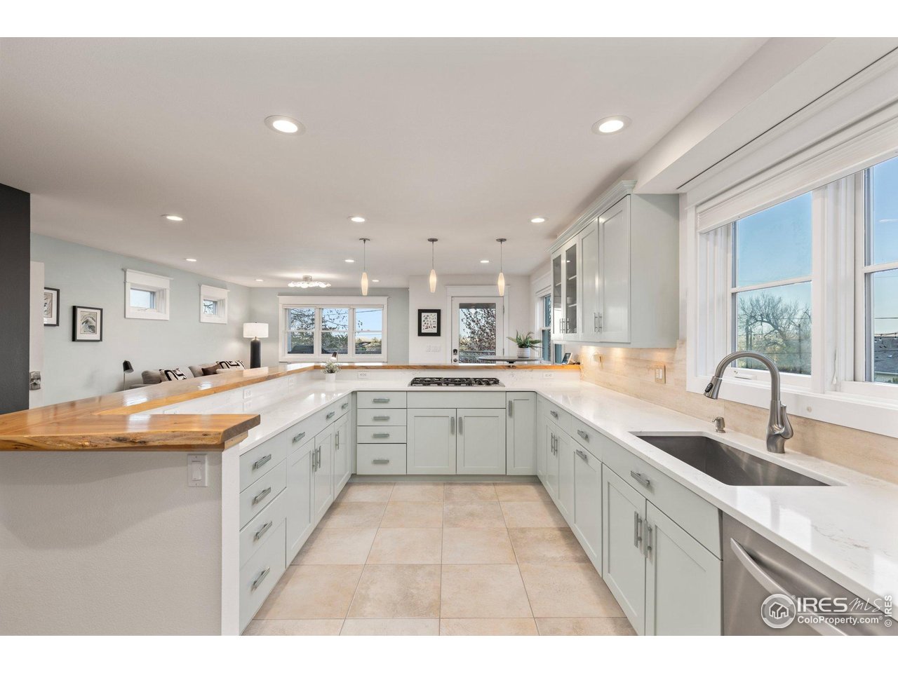 2942 4th Street Boulder, CO 80304 - Photo 12 of 40 a large kitchen with granite countertop a sink and white cabinets
