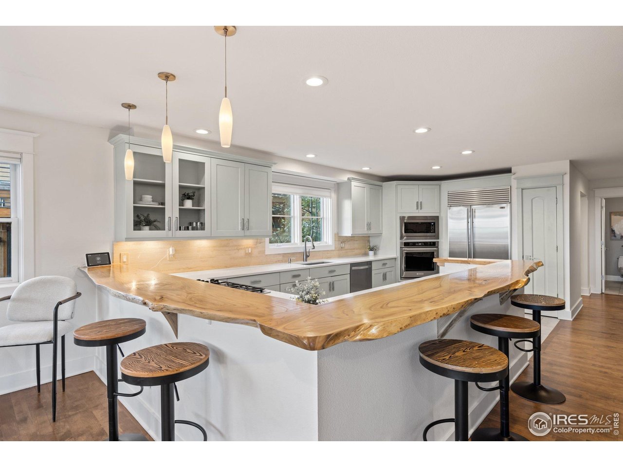 2942 4th Street Boulder, CO 80304 - Photo 13 of 40 a kitchen with stainless steel appliances kitchen island granite countertop a dining table and chairs