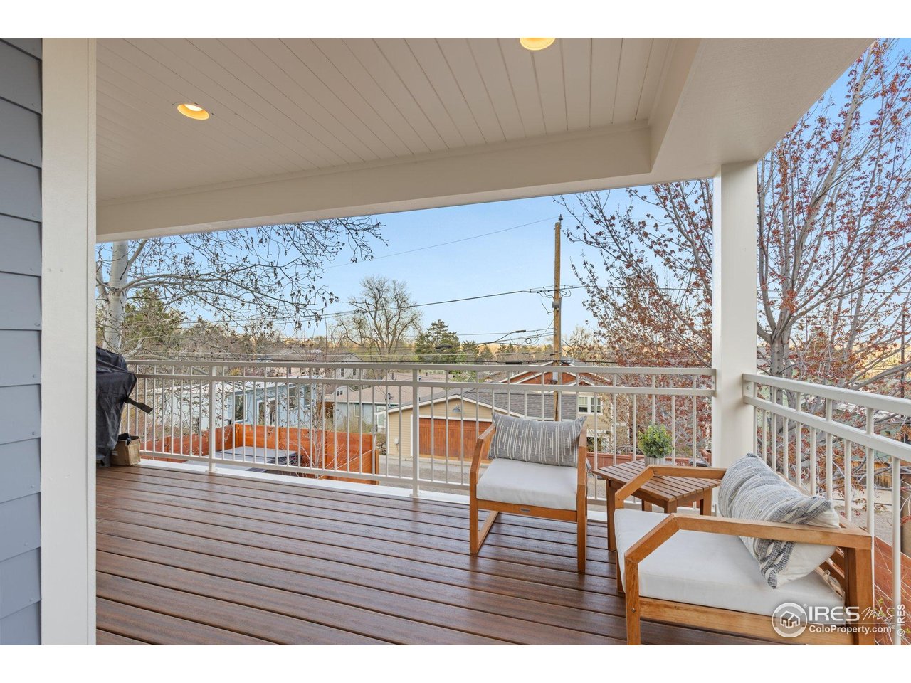 2942 4th Street Boulder, CO 80304 - Photo 17 of 40 a balcony with wooden floor table and chairs