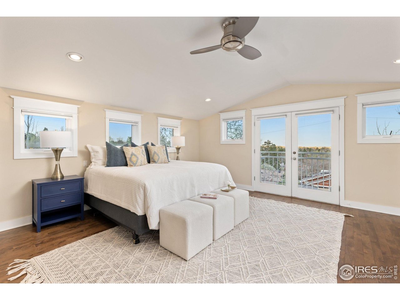 2942 4th Street Boulder, CO 80304 - Photo 18 of 40 a spacious bedroom with a bed a couch and large window