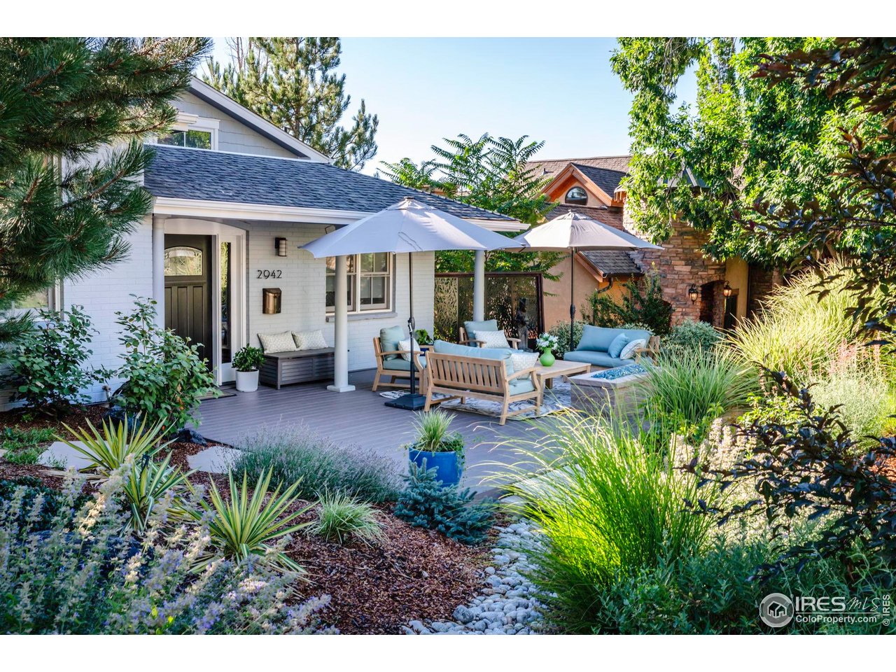 2942 4th Street Boulder, CO 80304 - Photo 2 of 40 a view of a patio with table and chairs potted plants and large tree