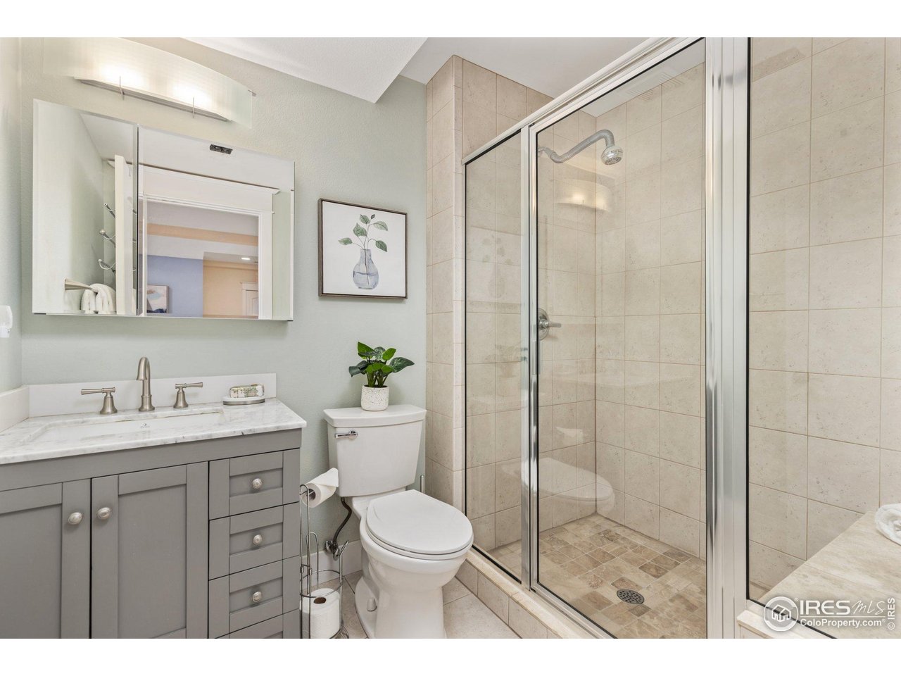 2942 4th Street Boulder, CO 80304 - Photo 27 of 40 a bathroom with a granite countertop sink toilet a mirror a glass door shower and