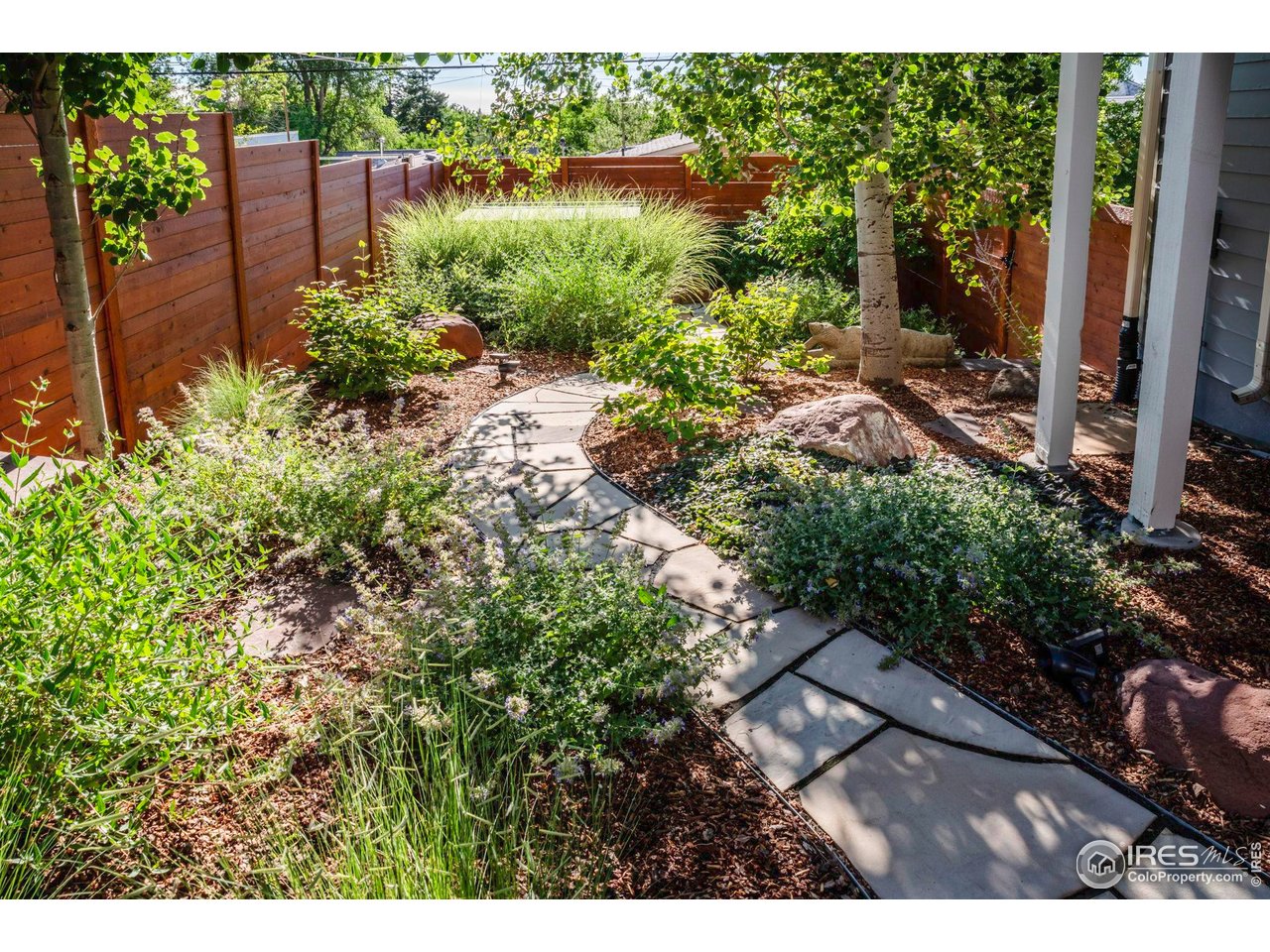 2942 4th Street Boulder, CO 80304 - Photo 30 of 40 a view of a garden with a bench