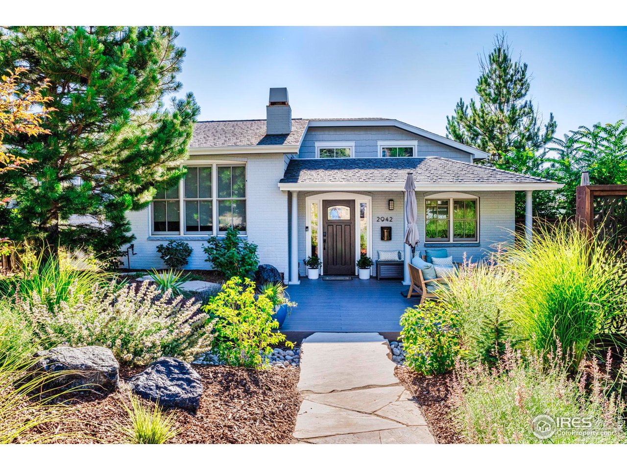 2942 4th Street Boulder, CO 80304 - Photo 6 of 40 a front view of a house with a yard and potted plants