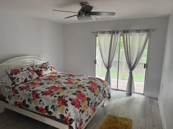 a bedroom with a bed and a large window