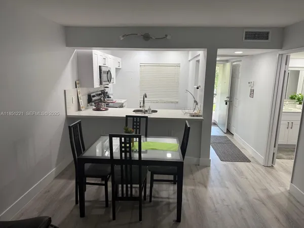 a dining room with furniture and wooden floor