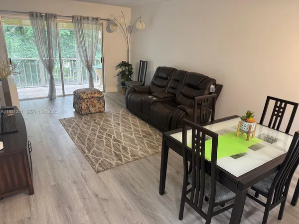 a living room with furniture and a floor to ceiling window