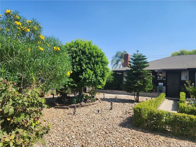 a view of a backyard with sitting area