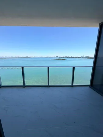 a view of a room with an empty space and a window