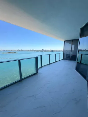 a view of an empty room with a kitchen