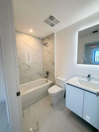 a bathroom with a toilet a sink and bathtub