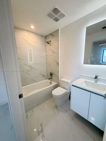 a bathroom with a sink a toilet and a bathtub
