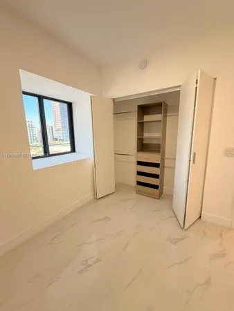 a view of an empty room with a bathroom