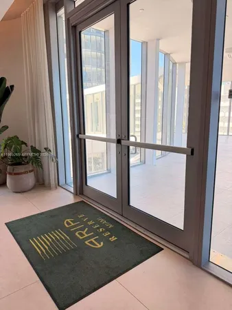 a dining room with furniture and a rug
