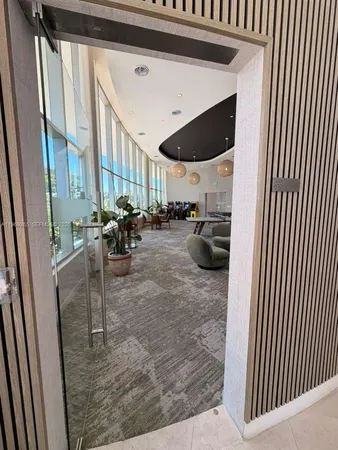 a very nice looking living room with a large window and furniture