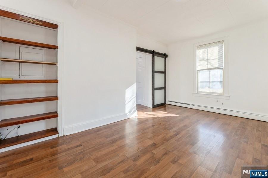 21 Central Avenue Tenafly, NJ 07670 - Photo 11 of 22 an empty room with wooden floor and windows