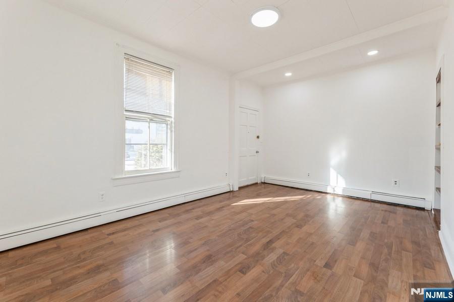 21 Central Avenue Tenafly, NJ 07670 - Photo 12 of 22 an empty room with wooden floor and windows