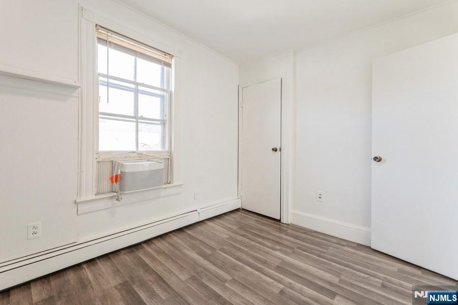 21 Central Avenue Tenafly, NJ 07670 - Photo 16 of 22 an empty room with wooden floor and windows