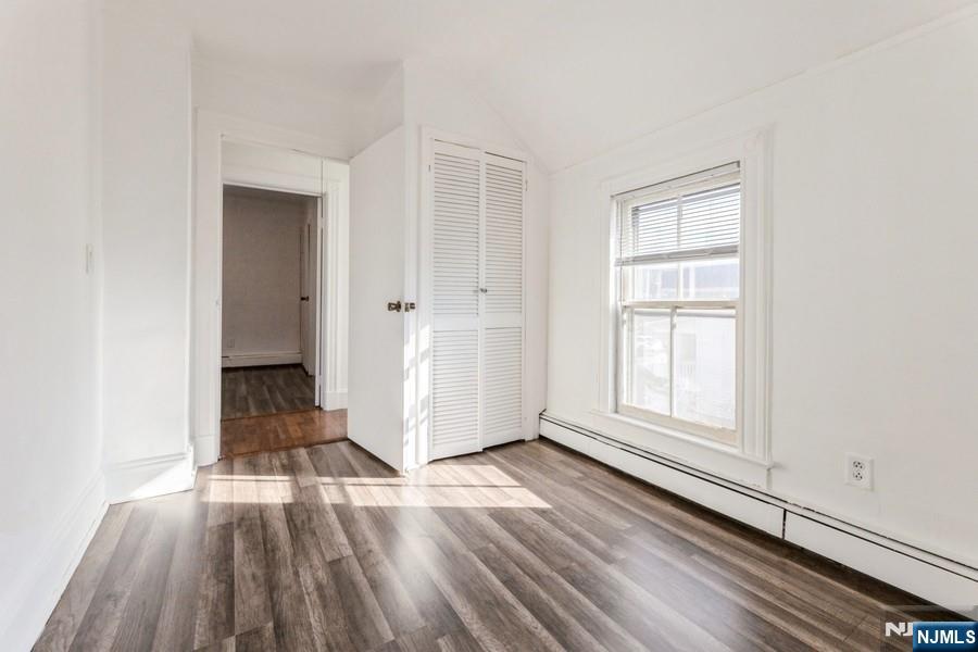 21 Central Avenue Tenafly, NJ 07670 - Photo 21 of 22 an empty room with wooden floor cabinet and windows