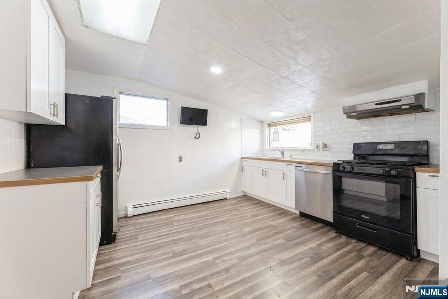 21 Central Avenue Tenafly, NJ 07670 - Photo 7 of 22 a kitchen with granite countertop a sink cabinets and stainless steel appliances