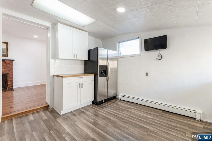 21 Central Avenue Tenafly, NJ 07670 - Photo 9 of 22 a view of a kitchen with white cabinets and stainless steel appliances