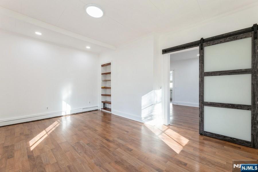 21 Central Avenue Tenafly, NJ 07670 - Photo 10 of 22 a view of empty room with wooden floor and fan