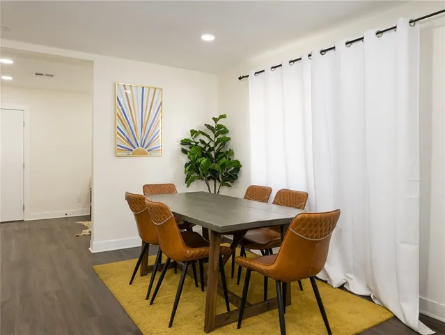 a dining room with furniture and wooden floor