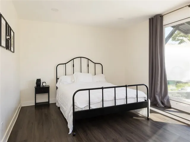 a bedroom with a bed and a large window