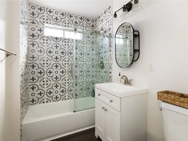 a bedroom with a bed and painting on the wall