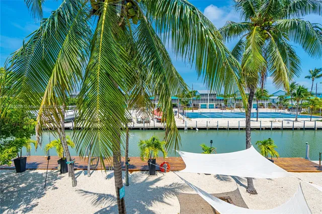 a living room with furniture a flat screen tv and a table