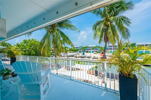 a spacious bedroom with a bed and a chandelier