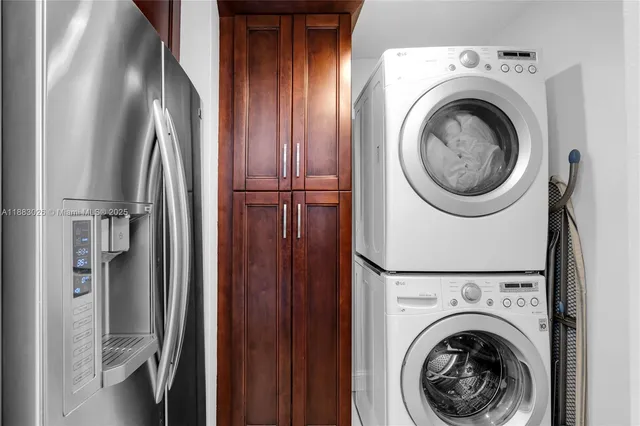 a dining room with furniture a rug a flat screen tv and a chandelier