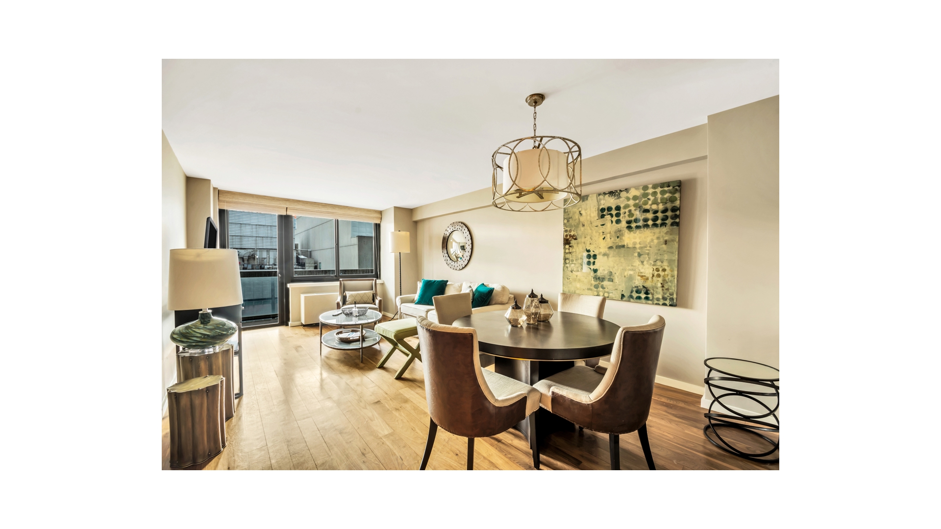 515 East 72nd Street, Unit 15D Manhattan, NY 10021 - Photo 4 of 10 a living room with furniture a chandelier and a dining table