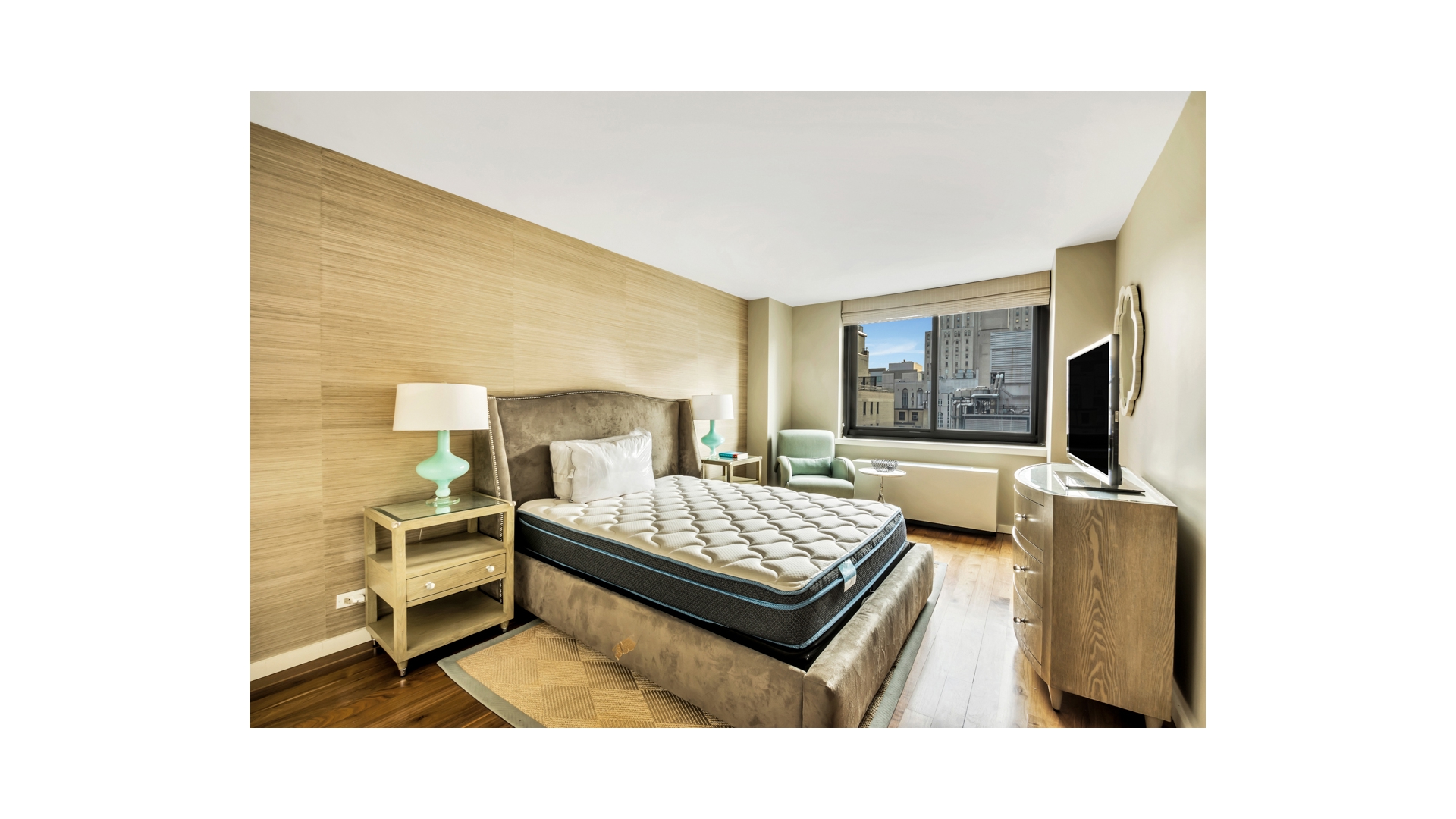 515 East 72nd Street, Unit 15D Manhattan, NY 10021 - Photo 7 of 10 a living room with furniture and a flat screen tv