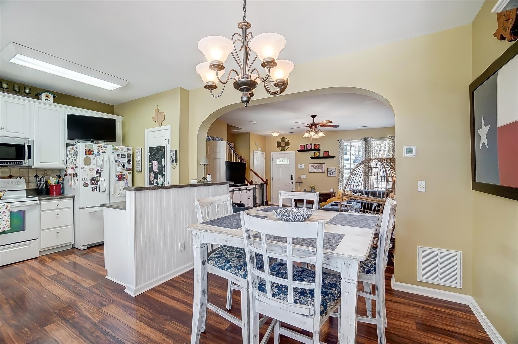 753 Shellstone Place, Unit 87 Fort Mill, SC 29708 - Photo 7 of 21 a view of a dining room with furniture a chandelier and wooden floor