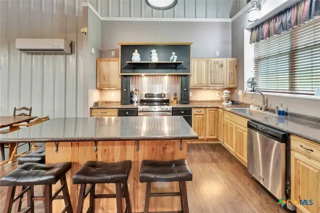 a kitchen with counter top space a sink and appliances