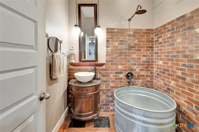 a bathroom with a granite countertop toilet sink and mirror