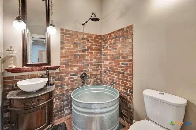 a bathroom with a toilet a sink and mirror