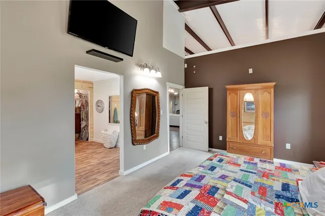 a bedroom with a bed and a television