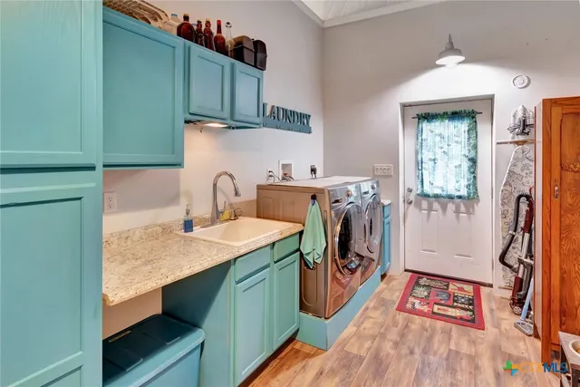 a utility room with sink a washer and dryer
