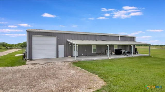 a view of a house with a yard and porch
